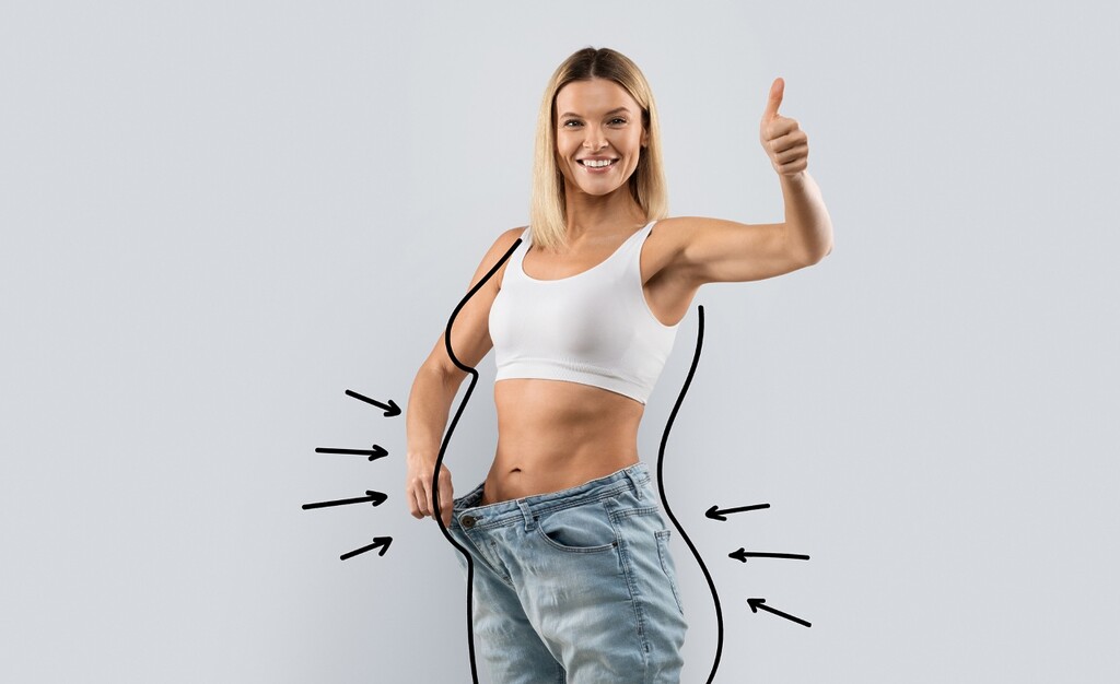 Cheerful attractive slim middle aged blonde woman wear over-sized jeans