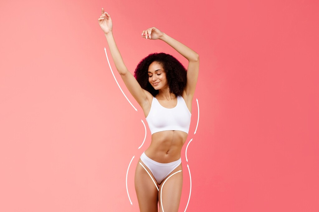 Athletic and healthy young lady proudly showing her toned physique