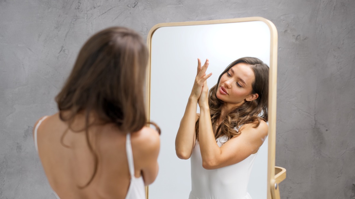 woman looking at a mirror